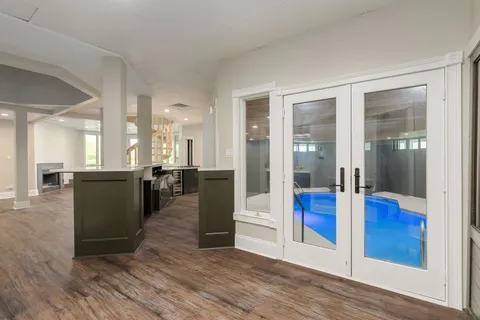 a view of a living room and kitchen with furniture and wooden floor