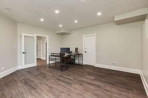 a view of work space with wooden floor and furniture