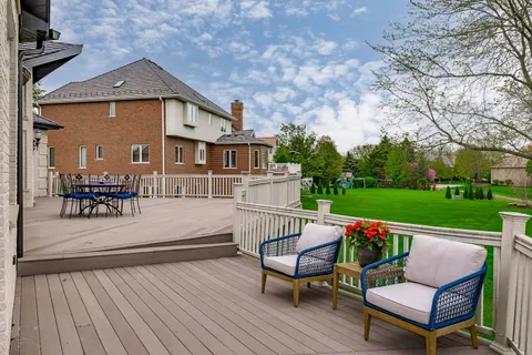 a view of a roof deck with furniture