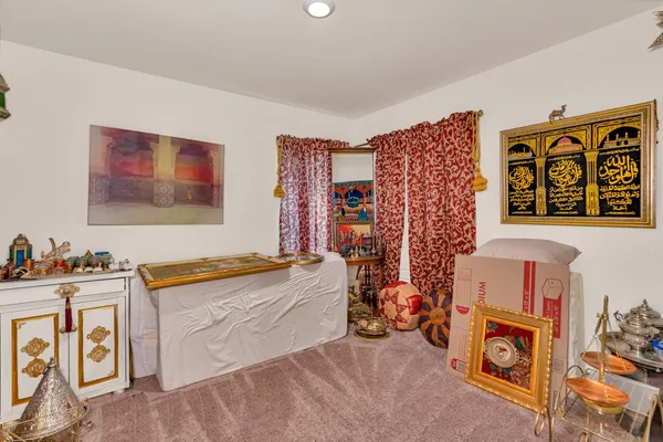 a view of a livingroom with furniture fridge and workspace