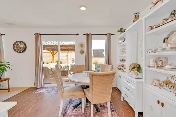 a dining room with furniture wooden floor and a rug