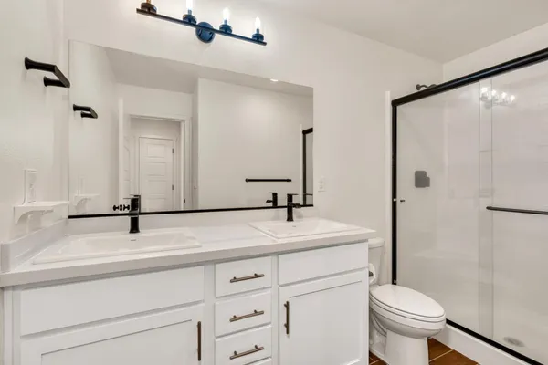 a bathroom with a shower and a toilet