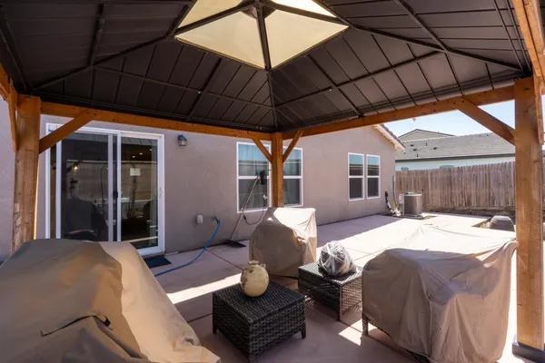 a backyard of a house with table and chairs