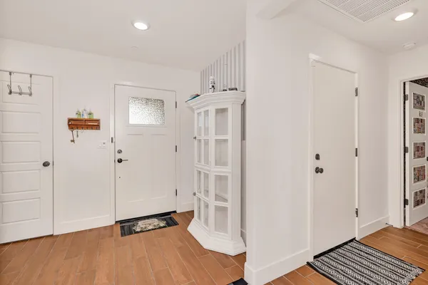 a view of a room with wooden floor and white doors