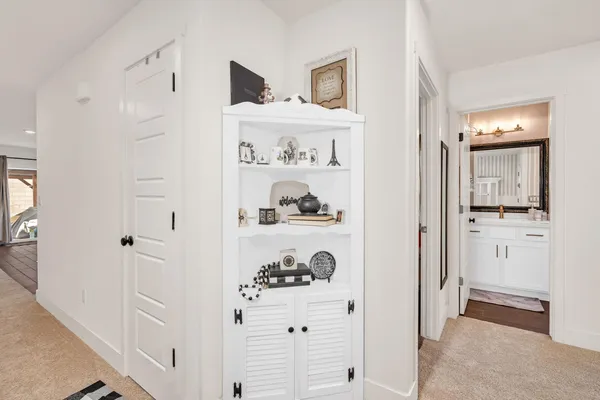 a view of kitchen with white cabinets and refrigerator