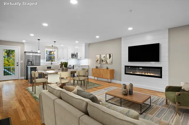 a living room with furniture wooden floor and a flat screen tv