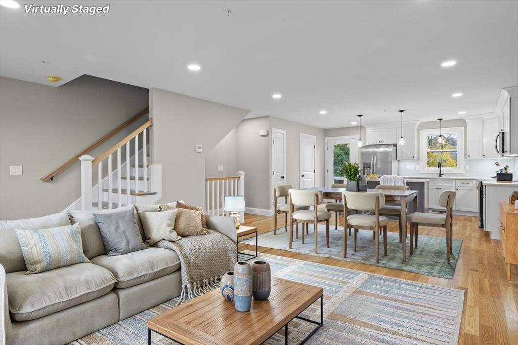 9 Acton Road, Unit 6 Chelmsford, MA 01824 - Photo 2 of 21 a living room with furniture kitchen view and a wooden floor
