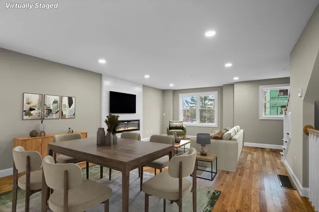 a view of a dining room with furniture window and wooden floor