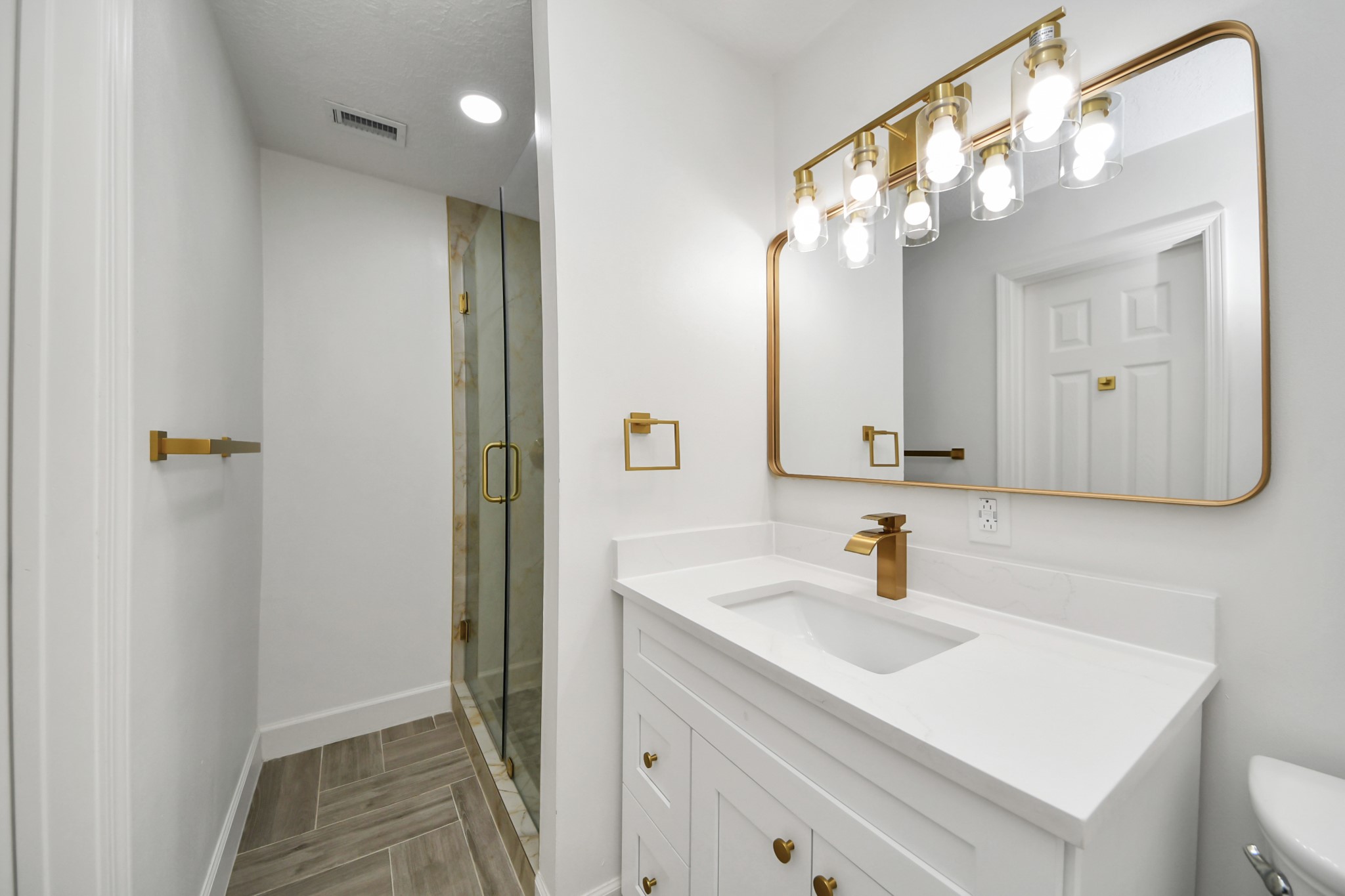 1719 Saddlecreek Drive Houston, TX 77090 - Photo 11 of 38 a bathroom with a sink vanity and a mirror