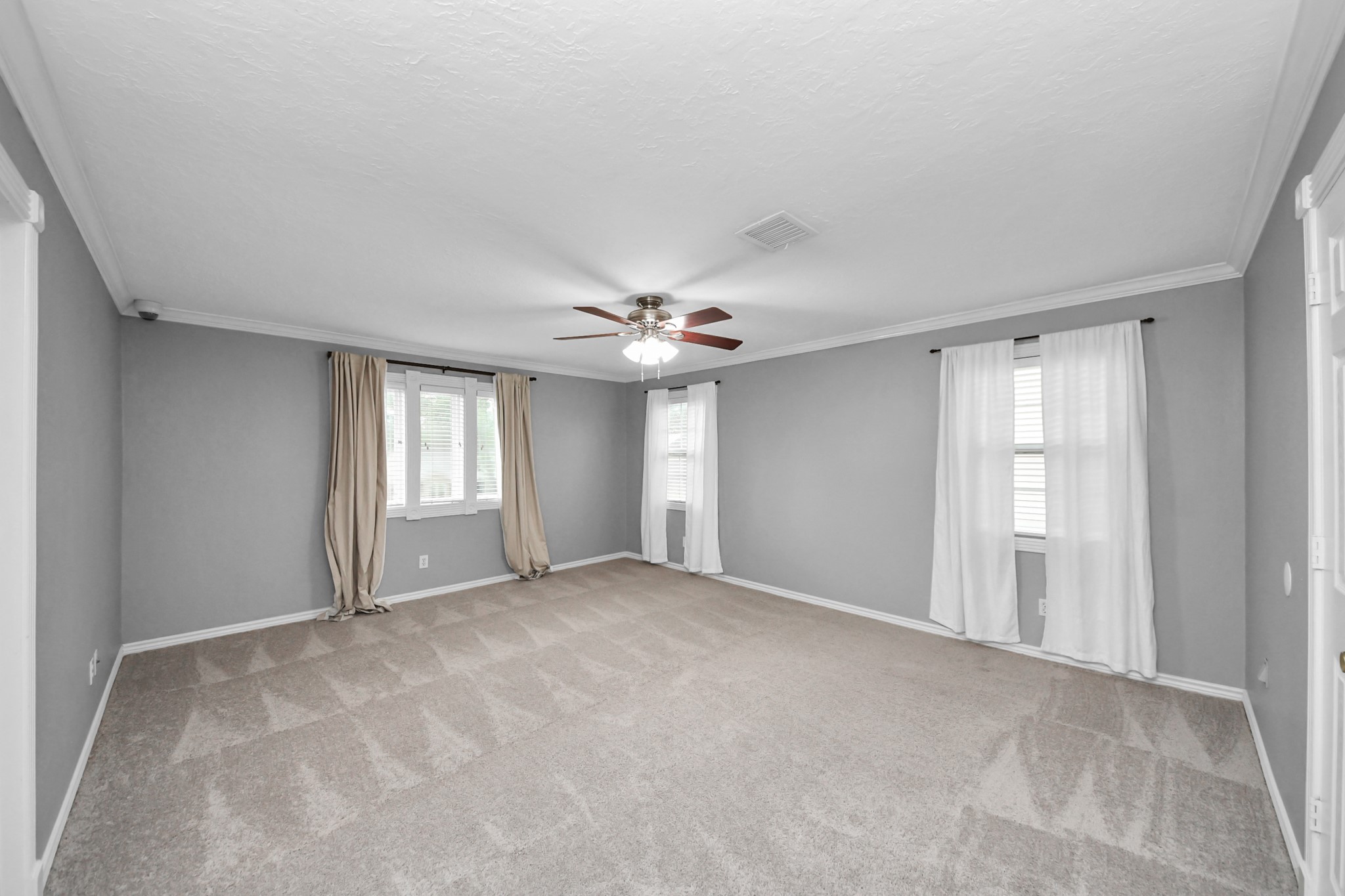 1719 Saddlecreek Drive Houston, TX 77090 - Photo 19 of 38 a view of an empty room with chandelier fan and windows