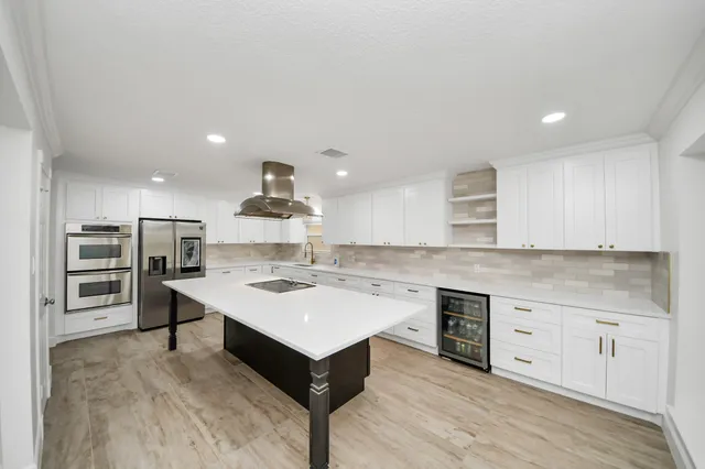 a kitchen with a stove cabinets and wooden floor