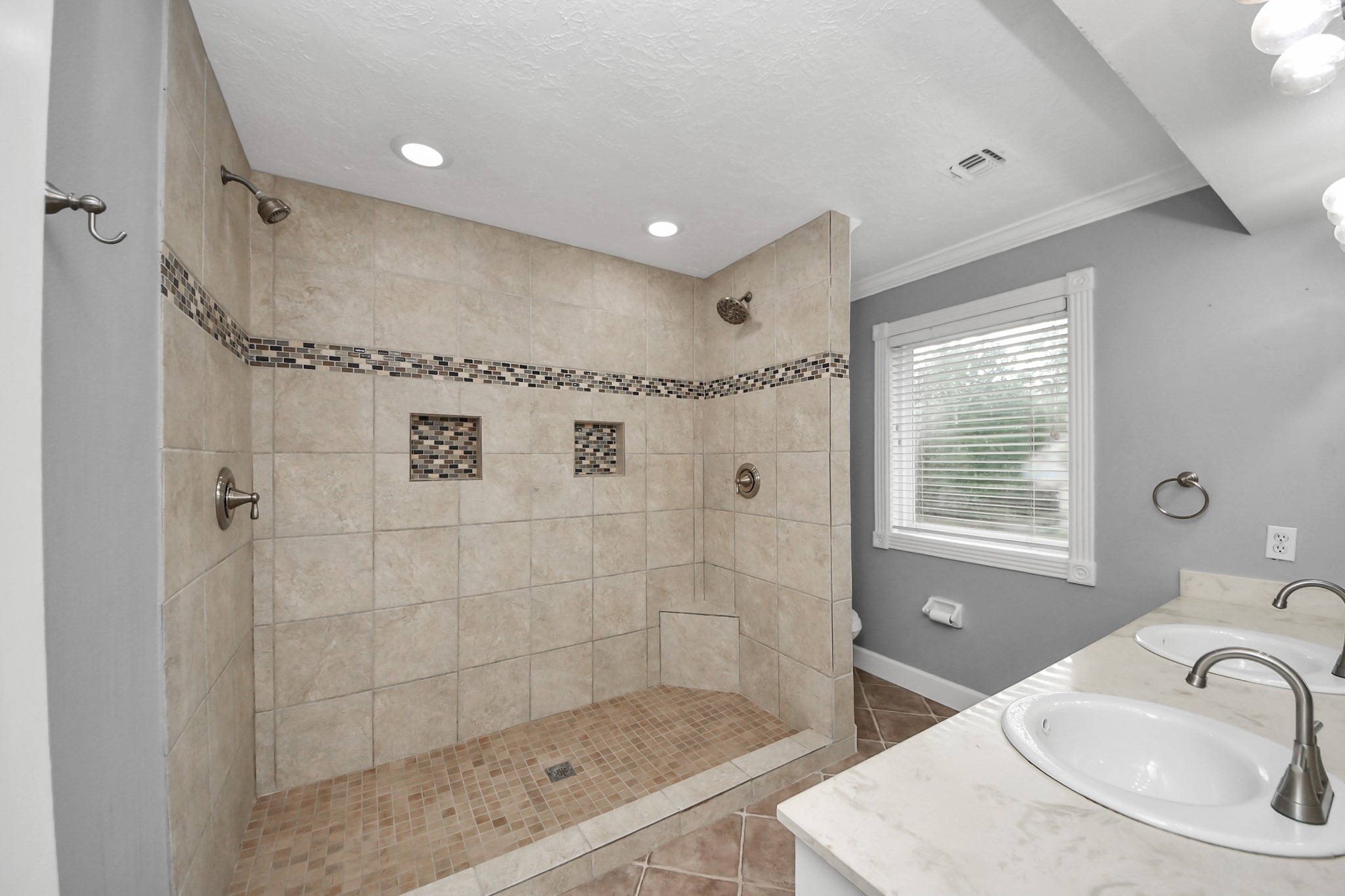 1719 Saddlecreek Drive Houston, TX 77090 - Photo 22 of 38 a bathroom with a sink shower and a mirror