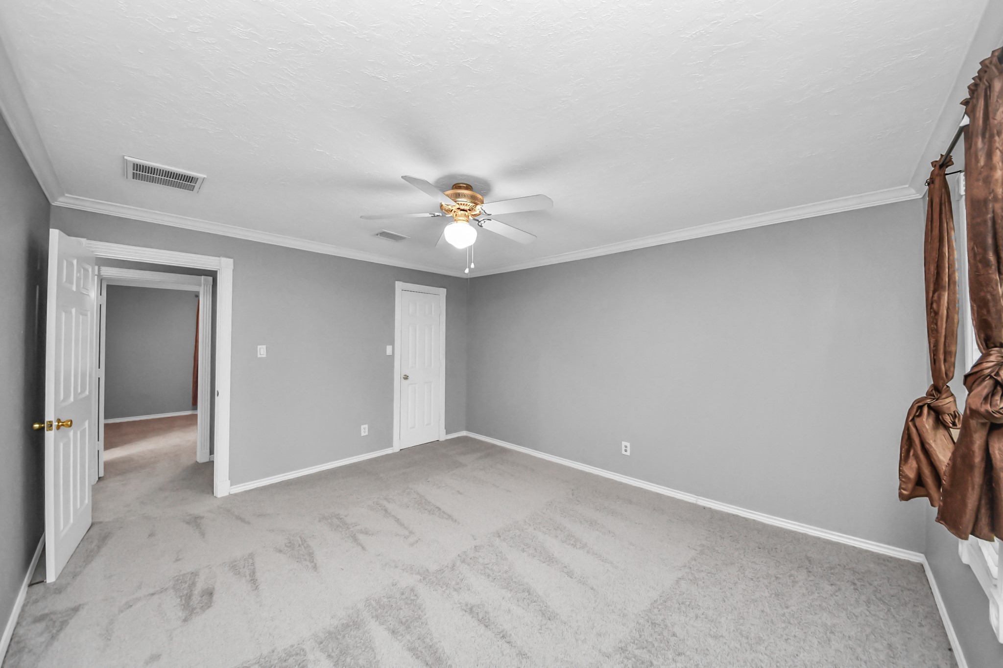 1719 Saddlecreek Drive Houston, TX 77090 - Photo 24 of 38 a view of an empty room with a chandelier fan