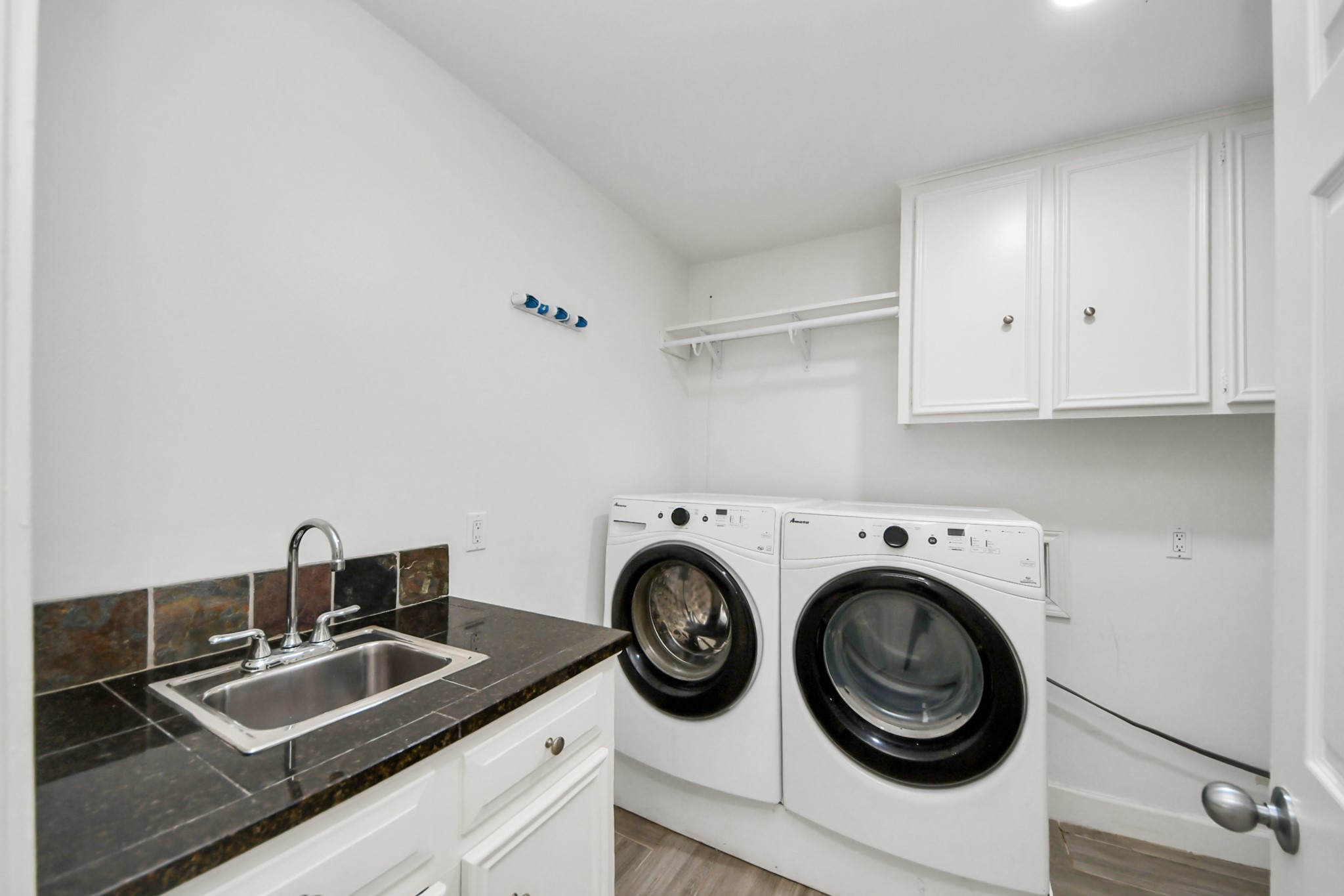1719 Saddlecreek Drive Houston, TX 77090 - Photo 29 of 38 a view of a sink and cabinets in a room