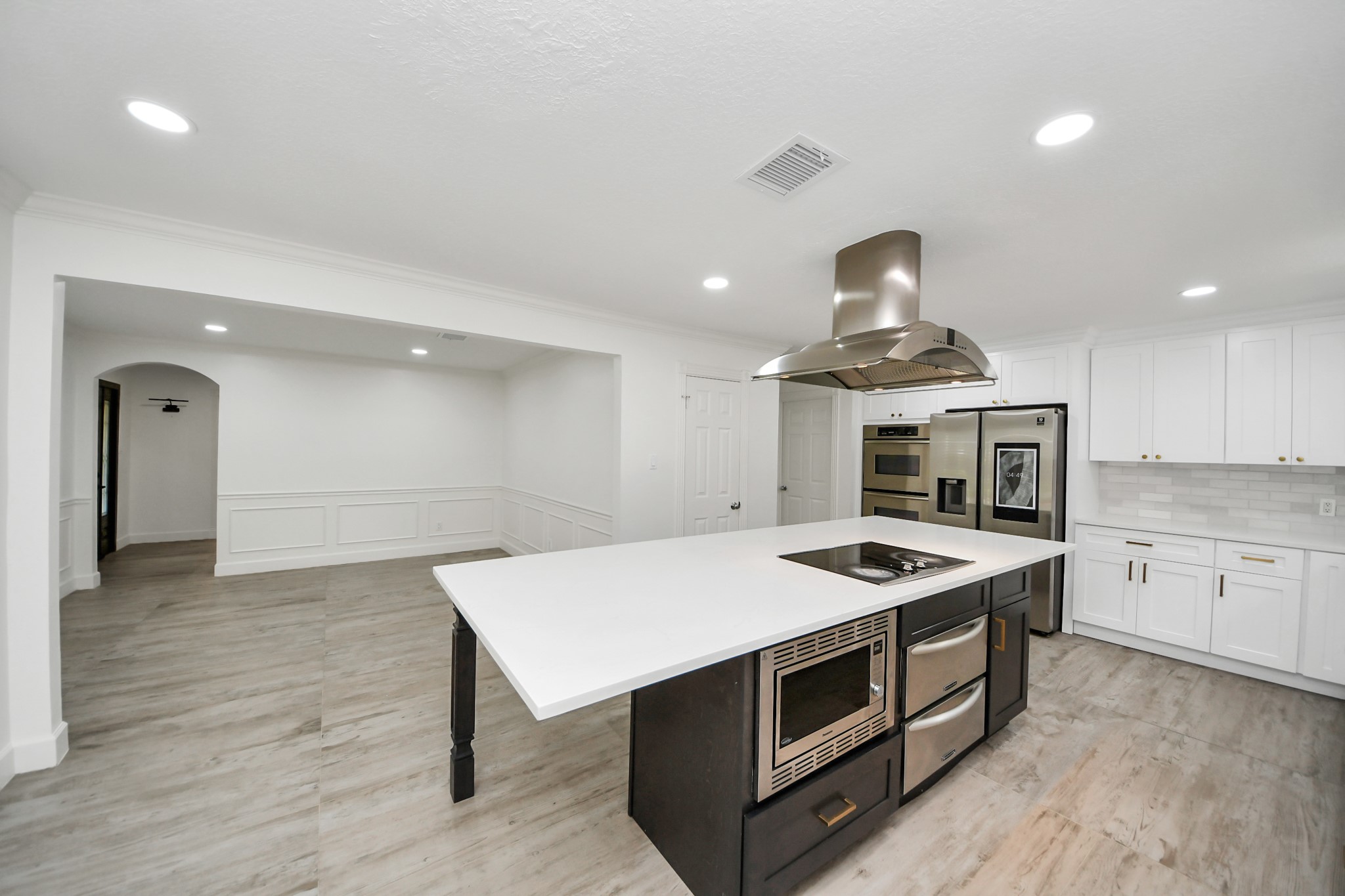 1719 Saddlecreek Drive Houston, TX 77090 - Photo 4 of 38 a kitchen with a stove cabinets and wooden floor