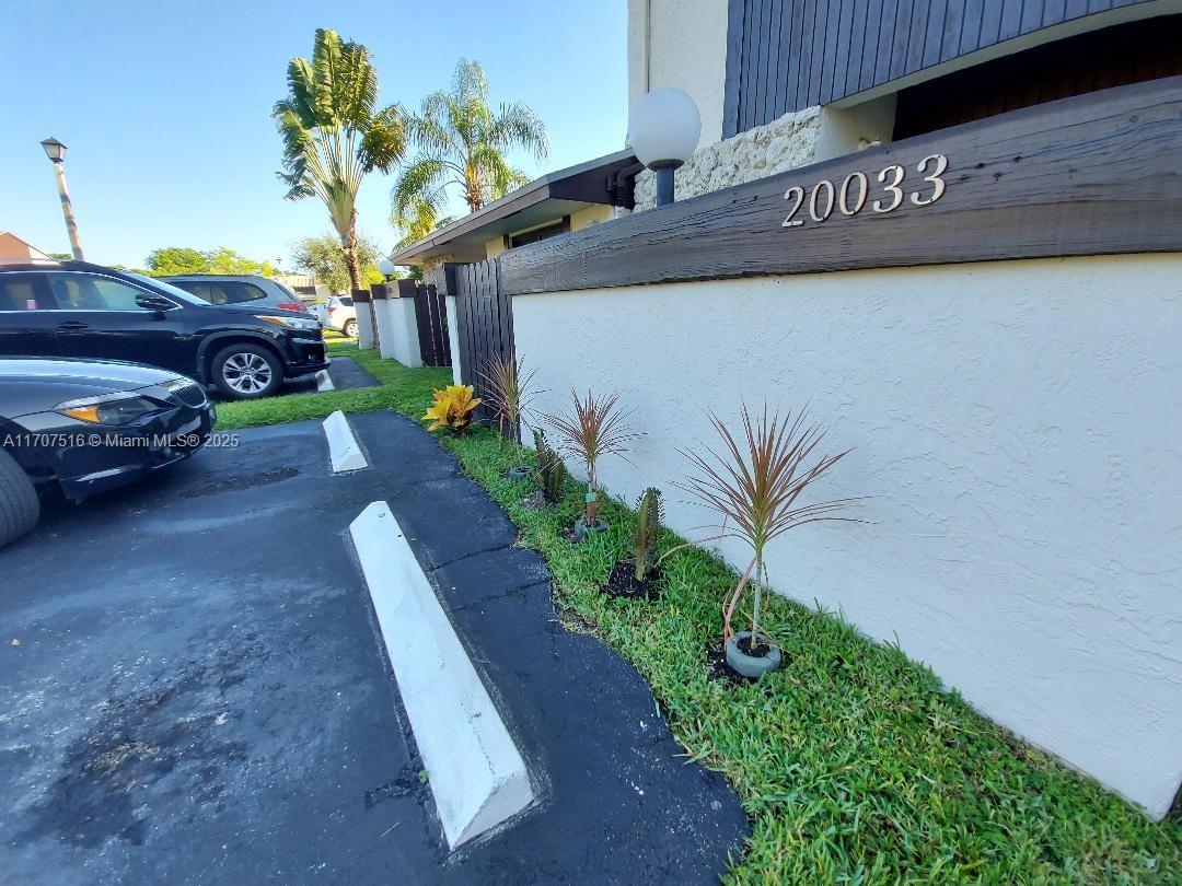 20033 Northeast 2nd Place, Unit 20033 Miami, FL 33179 - Photo 24 of 26 a view of a street with potted plants