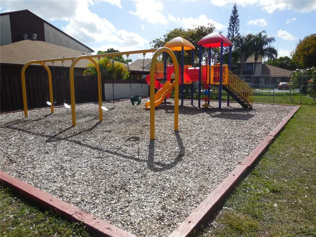 a swimming pool with some potted plants