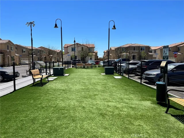 a view of a patio with dining table and chairs under an umbrella