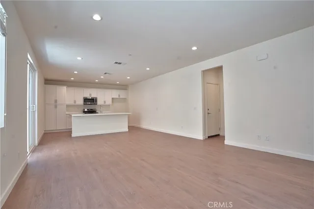 a kitchen with a sink a stove a microwave and cabinets