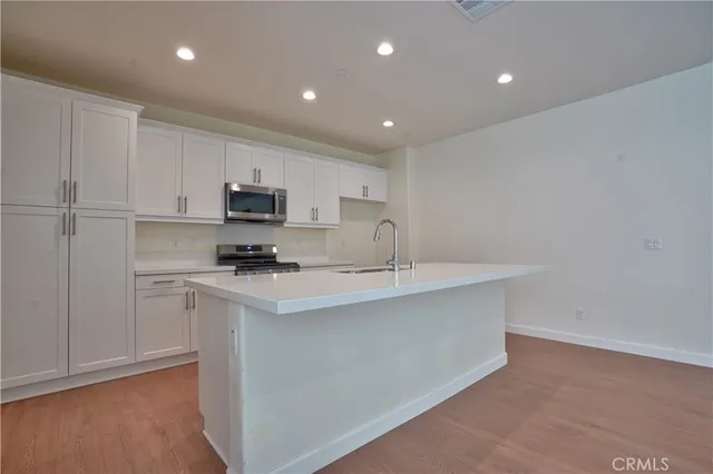 a kitchen with sink and mirror