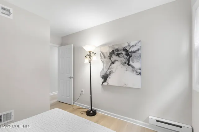 a view of a bedroom with a bed and cabinet