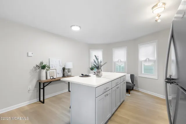 a room with a sink appliances and a window