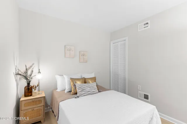 a bedroom with a bed and a lamp with the wall