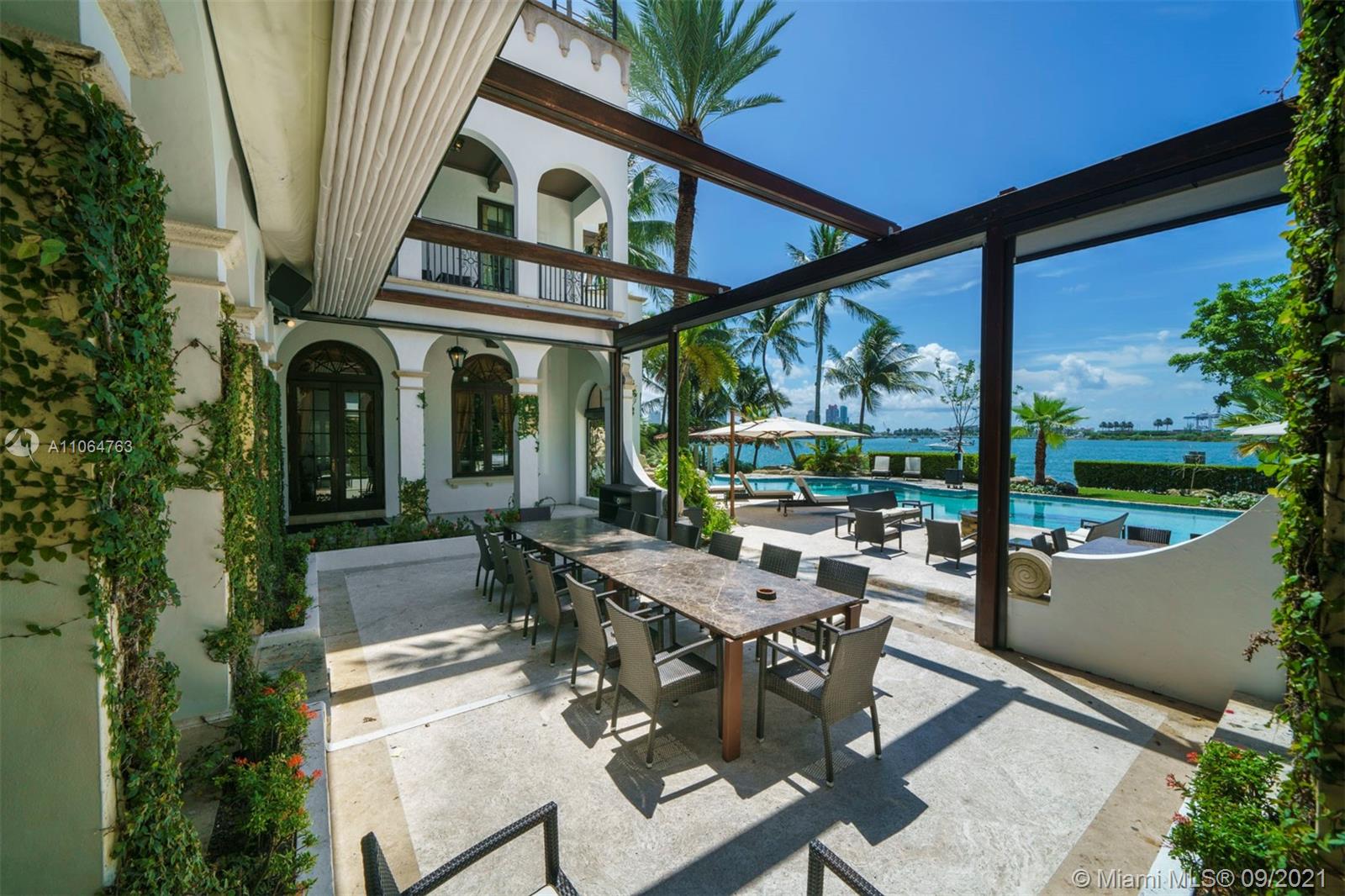 10 Palm Avenue Miami Beach, FL 33139 - Photo 16 of 42 a view of an outdoor dining space with a table and chairs