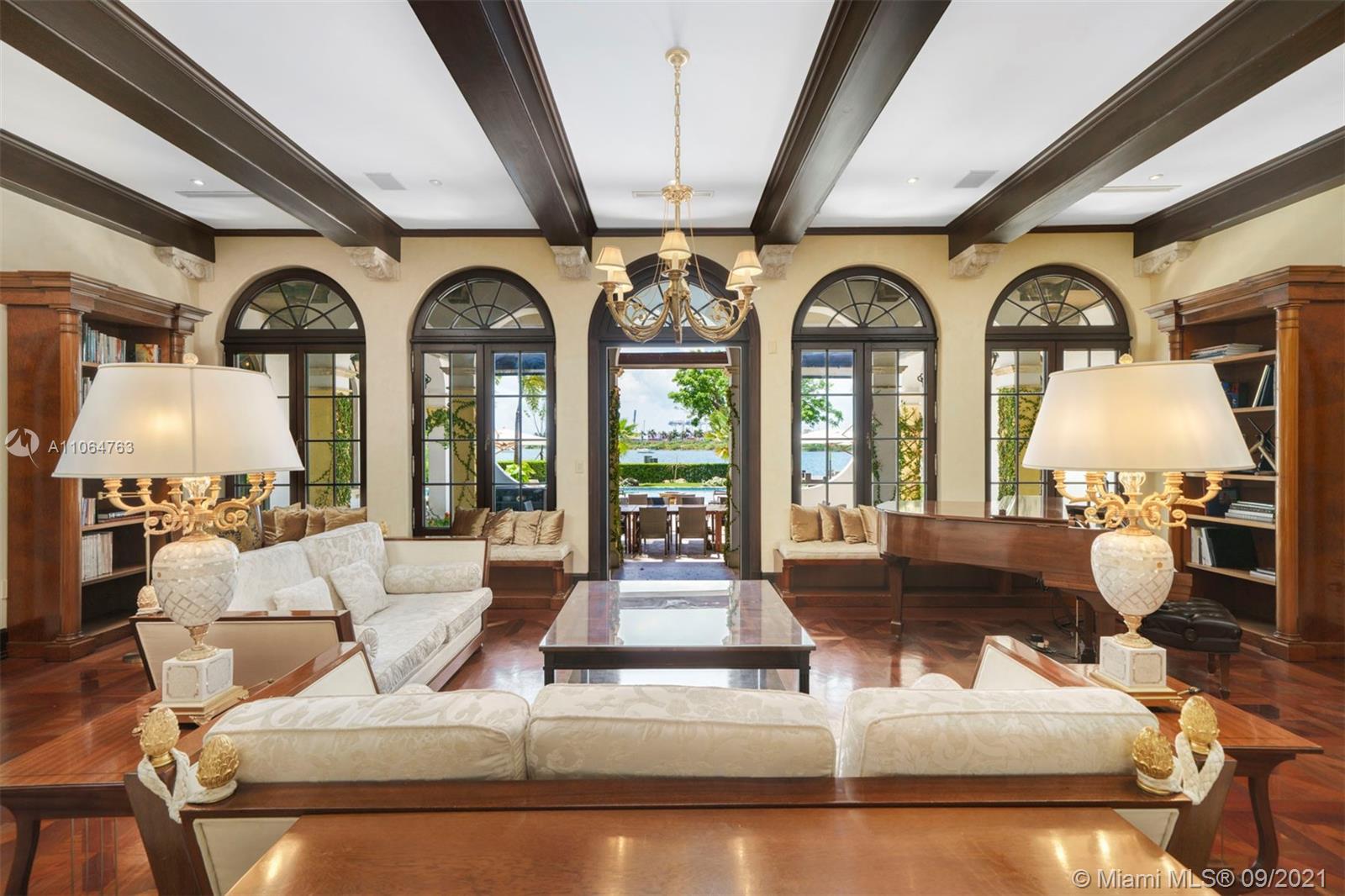 10 Palm Avenue Miami Beach, FL 33139 - Photo 18 of 42 a living room with couches painting on wall and a large window