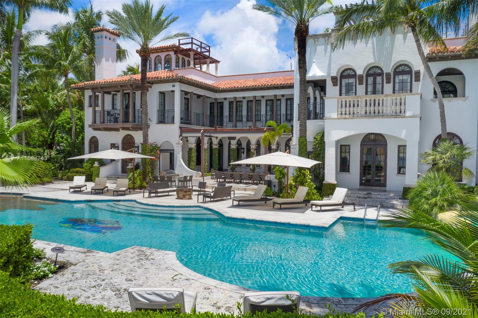 10 Palm Avenue Miami Beach, FL 33139 - Photo 5 of 42 a front view of a house with garden and swimming pool