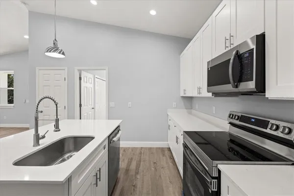 a kitchen that has a sink and a stove