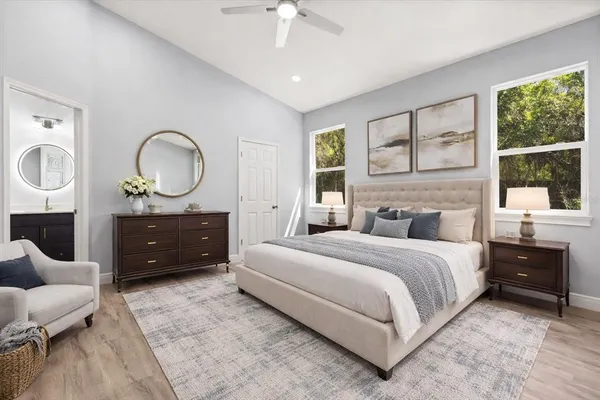 a bedroom with a bed a chandelier and a window