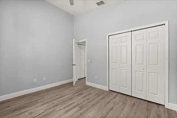 a view of an empty room with wooden floor