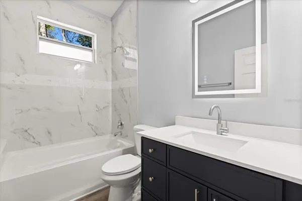 a bathroom with a sink a toilet and a bathtub