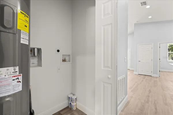 a view of hallway with wooden floor