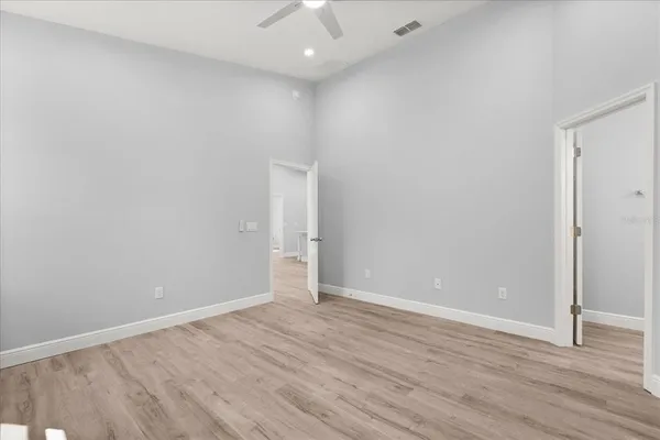 a view of an empty room with wooden floor
