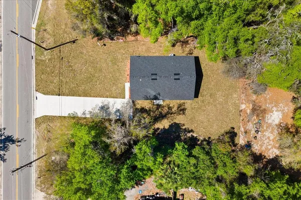 an aerial view of a house with a yard