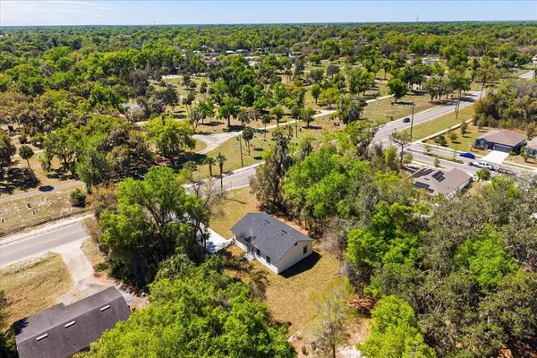 an aerial view of residential houses with outdoor space