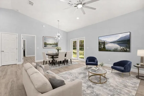 a living room with furniture and wooden floor