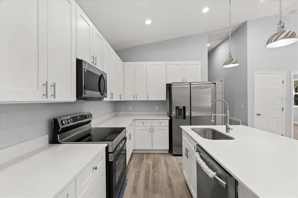 a kitchen with a sink a stove and refrigerator
