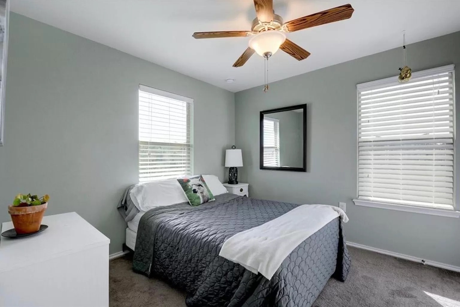 9016 Ridgewell Road Austin, TX 78747 - Photo 21 of 30 A well-lit bedroom offering a cozy retreat with a versatile ceiling fan and generous natural light.