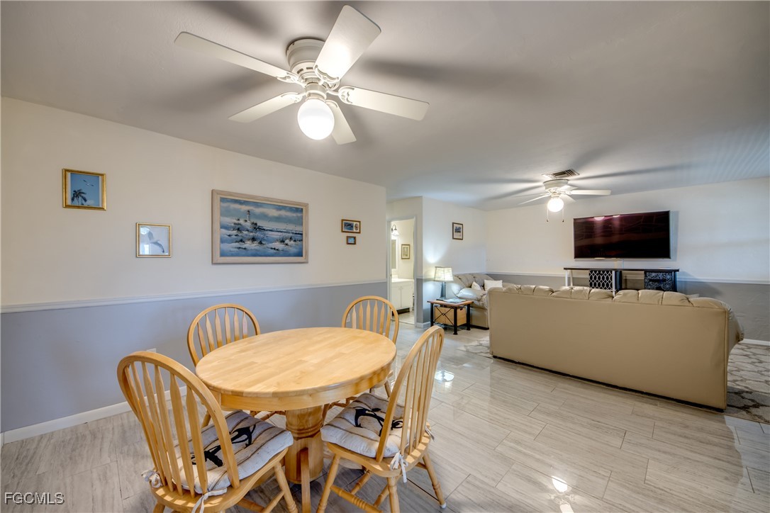 909 Southeast 46th Lane, Unit 202 Cape Coral, FL 33904 - Photo 11 of 38 a living room with furniture and a flat screen tv