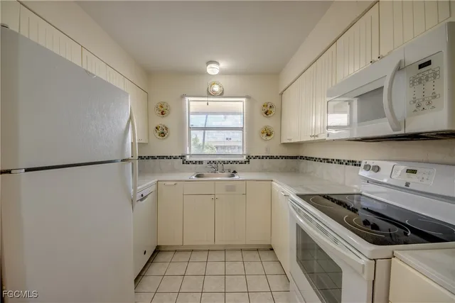a kitchen with a stove a sink and a refrigerator