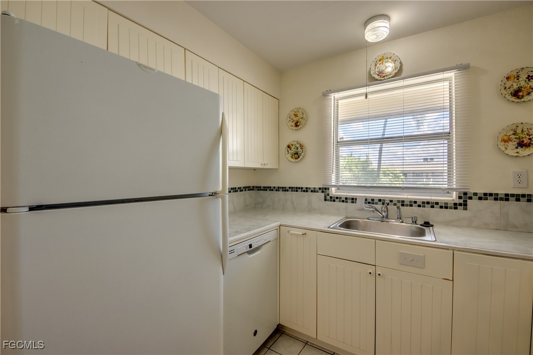 909 Southeast 46th Lane, Unit 202 Cape Coral, FL 33904 - Photo 15 of 38 a bathroom with a sink and mirror