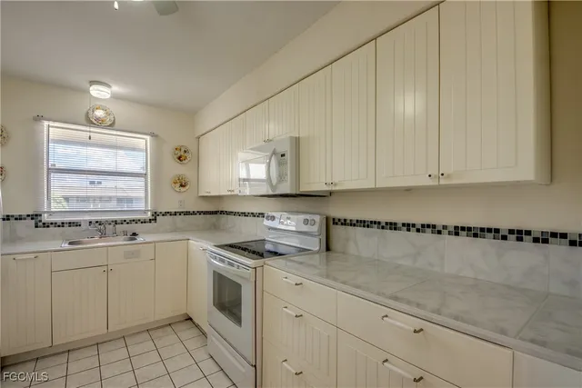 a kitchen with a sink stove and cabinets