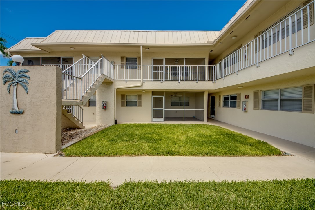 909 Southeast 46th Lane, Unit 202 Cape Coral, FL 33904 - Photo 2 of 38 a front view of a house with a garden