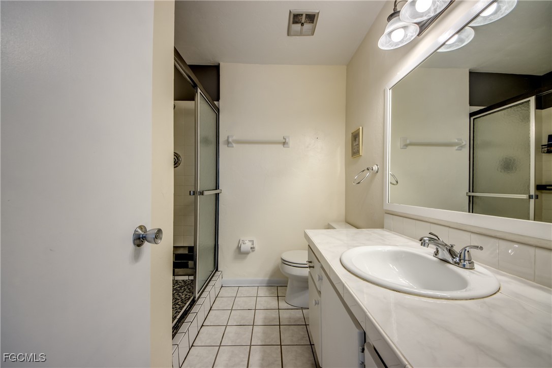 909 Southeast 46th Lane, Unit 202 Cape Coral, FL 33904 - Photo 22 of 38 a bathroom with a sink a toilet and shower
