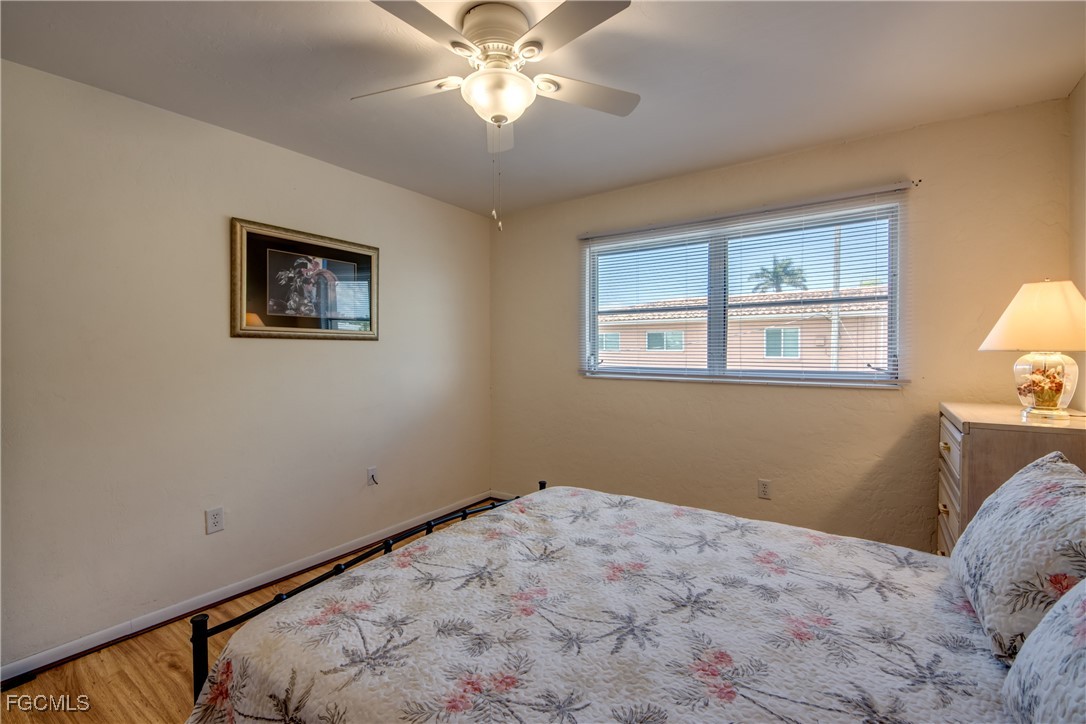 909 Southeast 46th Lane, Unit 202 Cape Coral, FL 33904 - Photo 26 of 38 a bedroom with bed and window