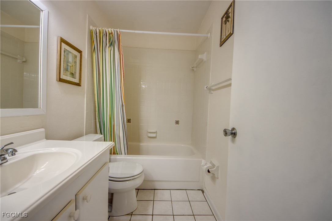 909 Southeast 46th Lane, Unit 202 Cape Coral, FL 33904 - Photo 27 of 38 a bathroom with a sink toilet and shower