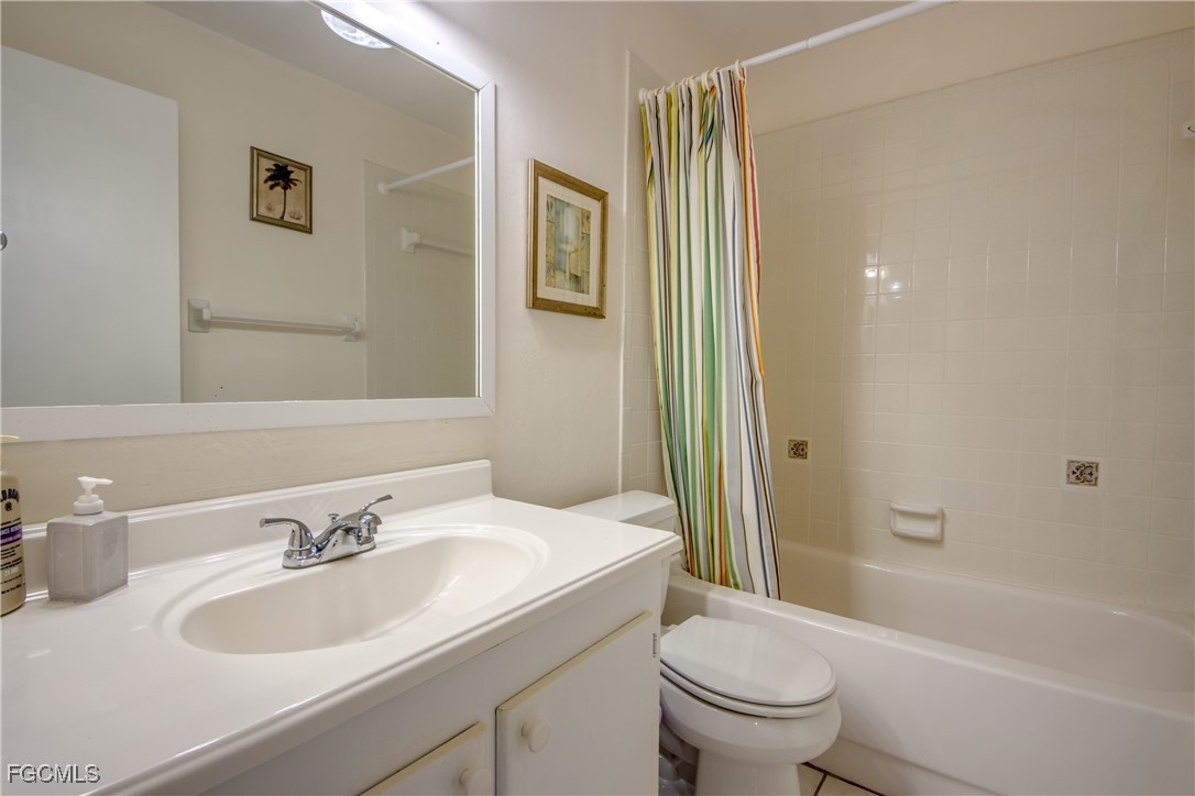 909 Southeast 46th Lane, Unit 202 Cape Coral, FL 33904 - Photo 28 of 38 a bathroom with a sink toilet and shower